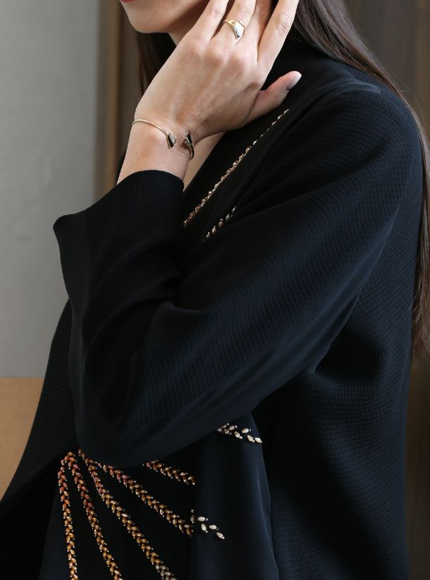 Gilded Dawn, Mesmerizing Black Abaya featuring a One-Sided Rose Gold Sun Rising Pattern.