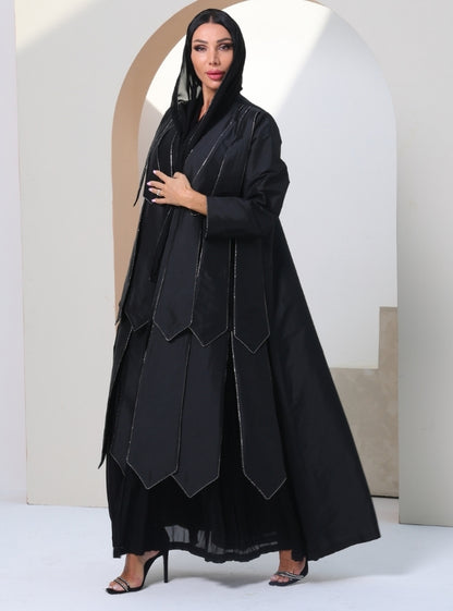 Timeless Canvas: Onyx Abaya adorned with glistening crystals, pleated with contemporary allure.